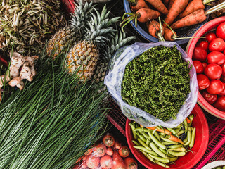 Top view on a large assortment of row loose vegetables and fruits for sale in a street. Short...