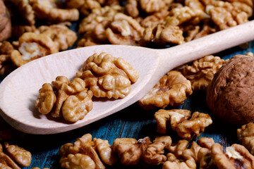 Food background. Peeled walnut close-up. Walnut kernels lie on a wooden spoon.