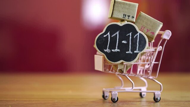 11.11 Single day sale. small cart with boxes and cloud shape blackboard