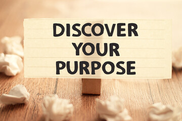 Discover your purpose, text words typography written on paper against wooden background, life and...