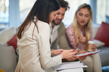 Fototapeta premium Group of three colleagues consulting together