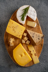 Cheese platter on wooden board. Cheese background. Closeup.