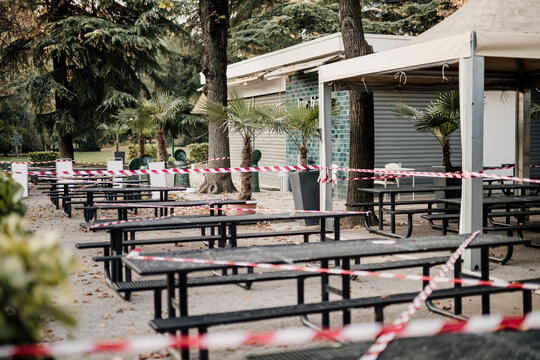 Cordon tape around seating outside cafe during 2020 Covid-19 Lockdown, Milan, Italy