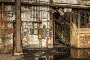 Large puddle with electrical meters in an abandoned factory in the deep south