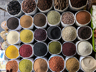 Top view on a assortment of various type of uncooked spice, beans, seeds, lentils, chickpeas