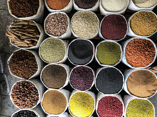 Top view on a assortment of various type of uncooked spice, beans, seeds, lentils, chickpeas