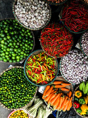 Fresh vegetables for sale at street food market in the old town of Hanoi, Vietnam. Garlic, Lemon,...