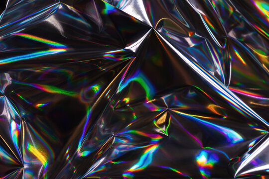 Abstract crumpled holographic background and texture.