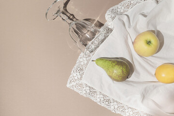 Summer still life composition made of fruits and glass on white cloth. Creative background. Freshness concept. Top view. Flat lay. Copy space