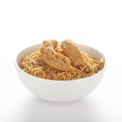Indian spicy snacks (Namkeen) - Bikaneri Besan Bhujia in a white bowl, made with chickpea flour (Besan), side view, against the white background.