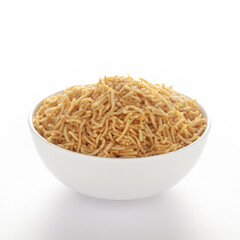 Indian spicy snacks (Namkeen) - Bikaneri Besan Bhujia in a white bowl, made with chickpea flour (Besan), side view, against the white background.