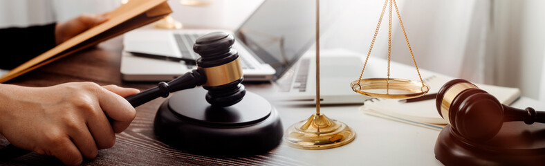 Business and lawyers discussing contract papers with brass scale on desk in office. Law, legal...