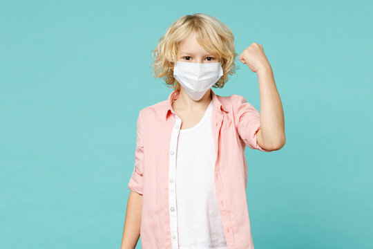 Happy little kid boy 10s in pink shirt sterile face mask safe from coronavirus virus covid-19 doing winner gesture isolated on blue turquoise background children portrait. Childhood lifestyle concept. - Powered by Adobe