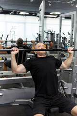 Man in the training gym  working hard after quarantine.