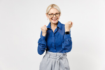 Blonde successful confident employee business woman 40s in blue classic shirt glasses formal clothes smart watch do winner gesture isolated on white background studio portrait. Achievement concept.
