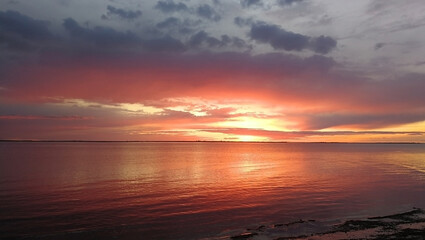 Soft orange sunset on the white Sea coast of northern Russia