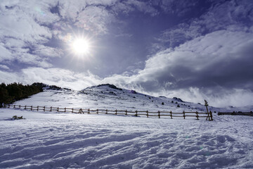 Snowscape on the mountain of Madrid with sun, blue sky and high mountain.
