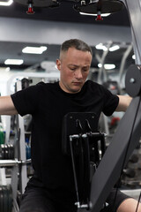 Man in the training gym  working hard after quarantine.