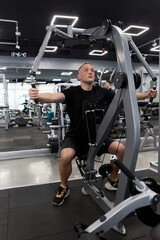 Man in the training gym  working hard after quarantine.