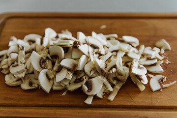 Sliced mushrooms close-up on a wooden board.