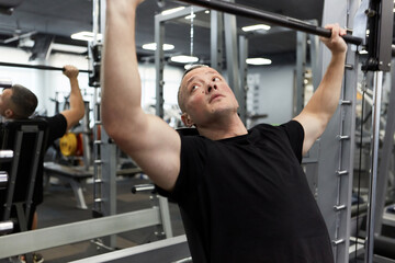 Man in the training gym  working hard after quarantine.