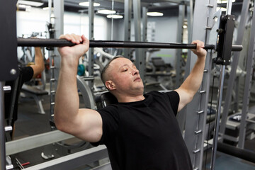 Man in the training gym  working hard after quarantine.