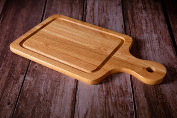 Cutting board with wooden dark background. Food cooking concept.