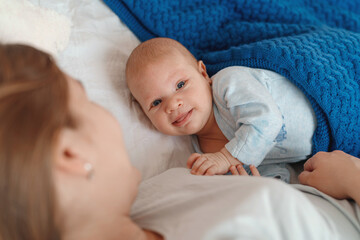 happy young woman feeds breast milk and hugs baby. a mother is breastfeeding