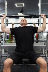 Man in the training gym  working hard after quarantine.