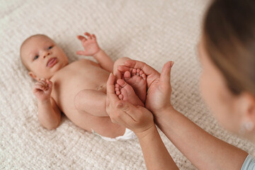 Close-up of children's foot massage on the bed.