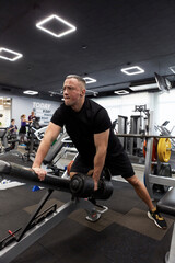 Man in the training gym  working hard after quarantine.