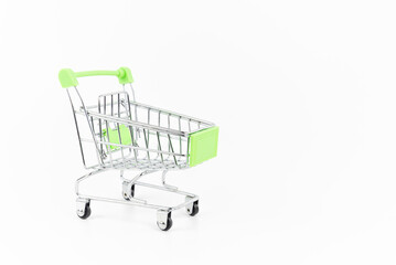 Mini silver shopping cart on white background. Shopping or e-commerce concept.