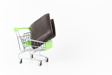 Mini silver shopping cart with wallet money on white background. Shopping or e-commerce concept.