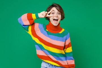 Excited surprised funny young brunette woman 20s years old wearing basic casual colorful sweater...