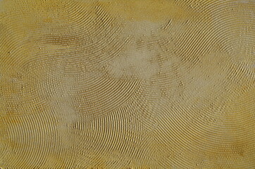 Decorative plaster in beige color with dark and light spots. small chaotic stripes, abstract illustration