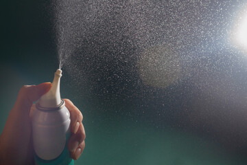 Spray the nasal spray with an aerosol. Small splashes of sea water. - obrazy, fototapety, plakaty