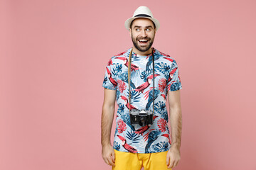 Excited young traveler tourist man in summer casual clothes hat with photo camera looking aside...