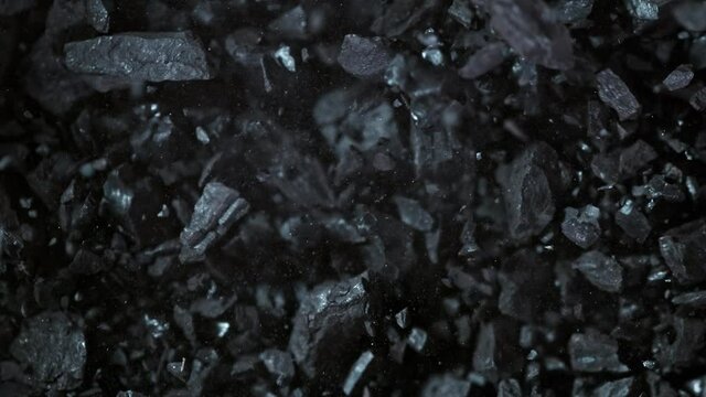 Super Slow Motion Shot of Crushing Coal on Black Background at 1000 fps.