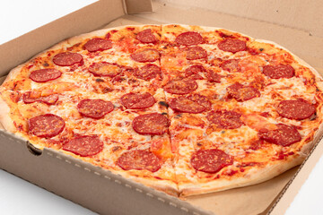 fresh aromatic hot Italian pepperoni pizza with mozzarella cheese in a cardboard box
