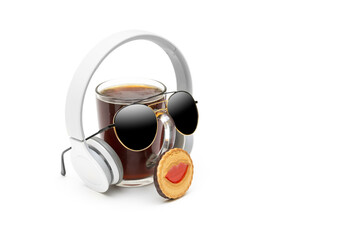 Funny composition made of a glass of cold coffee, headphones, sunglasses and a cookie isolated on white. Creative chilling concept. Studio shop, side view, copy space.