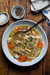 Comforting winter soup with chicken, pearl barley and vegetables