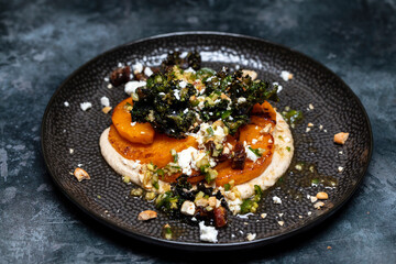 Butternut squash with cashew nuts puree, feta, kale and chillis