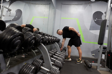 Man in the training gym  working hard after quarantine.