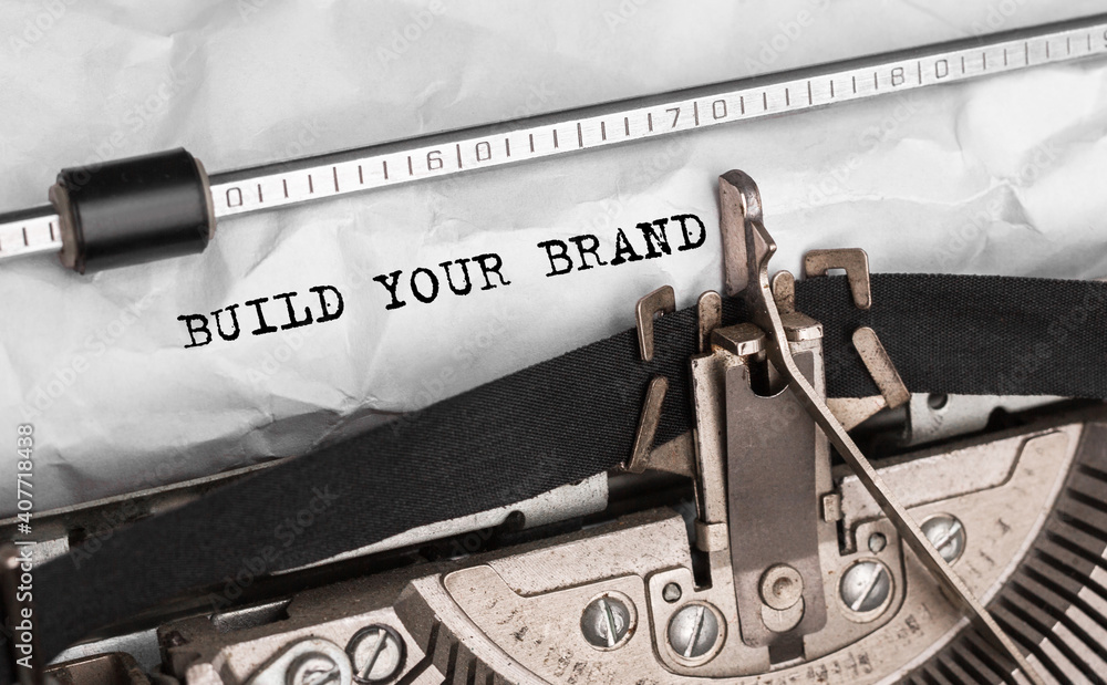 Aufkleber text build your brand typed on retro typewriter