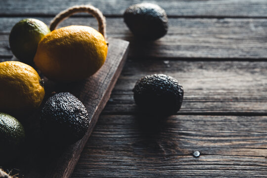 Avocado and Lemon with Knife on Old wooden Board, healthy food, vegetarianism, wellness