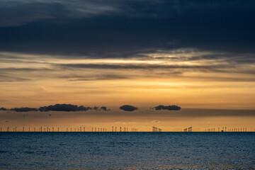 Naklejka premium Renewable energy off the coast at dusk