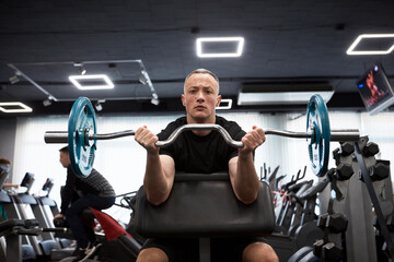 Man in the training gym  working hard after quarantine.