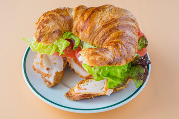 Sandwich of croissant of lettuce, tomato and smoked turkey