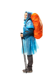 girl with hiking equipment and large backpack, wearing blue raincoat, posing in studio isolated on white