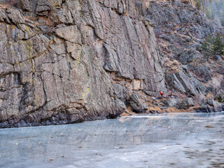 canyon of mountain river in winter scenery with distant rock climbers - Poudre River at Picnic Rock above Fort Collins, Colorado